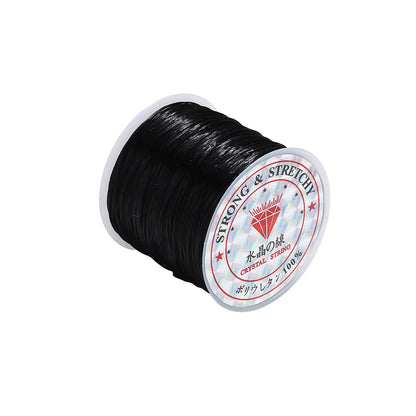 Spool of black thread with a label on a white background