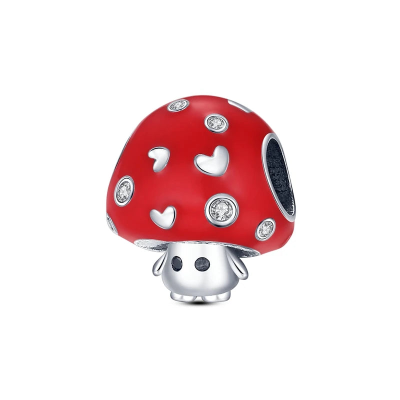 Red mushroom charm with silver accents on a white background