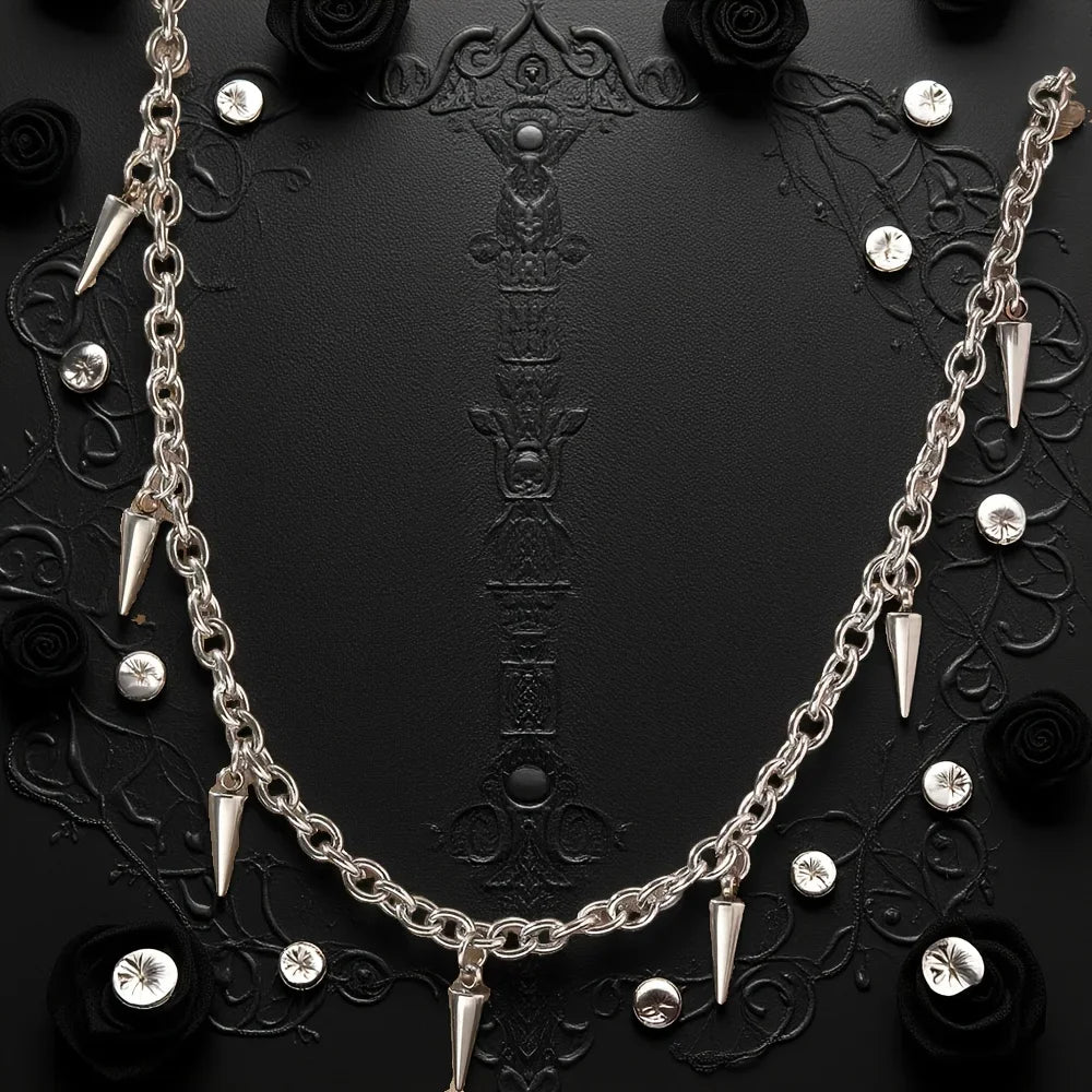 Silver chain necklace with spike-like pendants on a black background