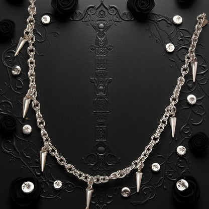 Silver chain necklace with spike-like pendants on a black background