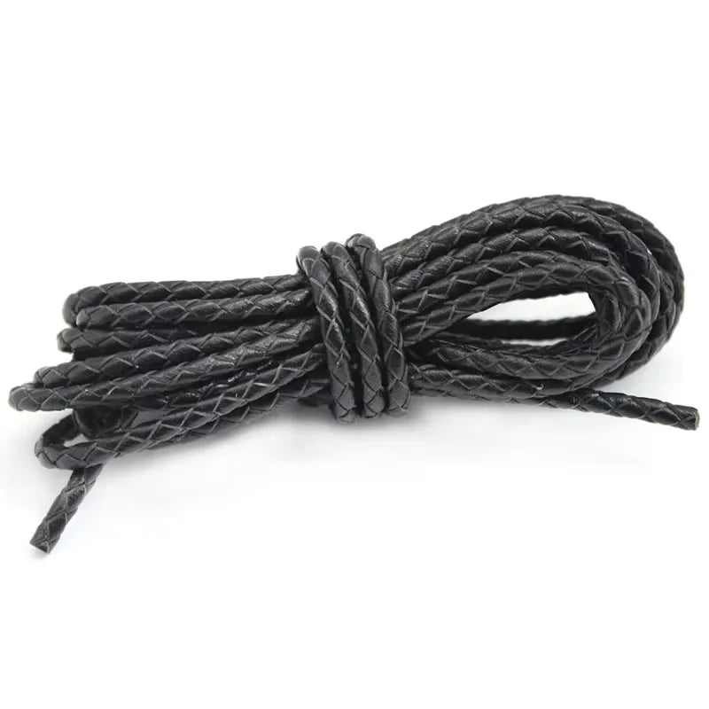 Black leather cord tied into a knot on a white background