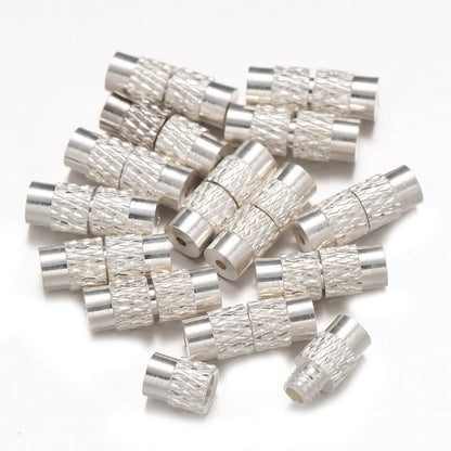 Silver metallic connectors on a white background