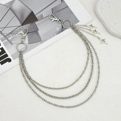 Silver chain necklace with star pendants on a magazine background