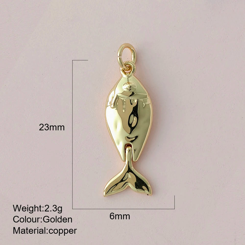 Gold fish-shaped pendant with measurements and material details on a light gray background