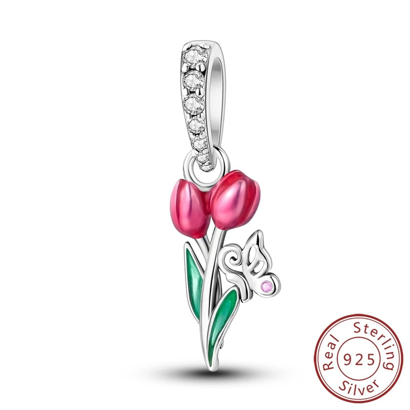 Silver pendant with pink tulips and a butterfly on a white background, featuring 'Real Sterling Silver 925' stamp.