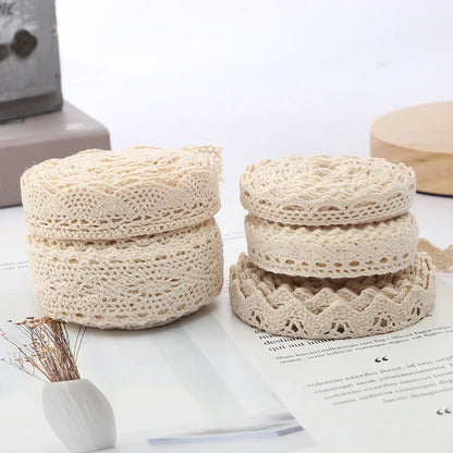 Two beige crochet containers on a white surface with a blurred background