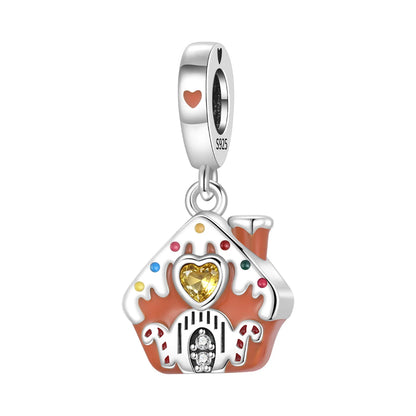 A silver-toned house-shaped charm with orange-red enamel details, a yellow heart-shaped crystal in the center, and small multicolored gem accents, shown on a plain white background.