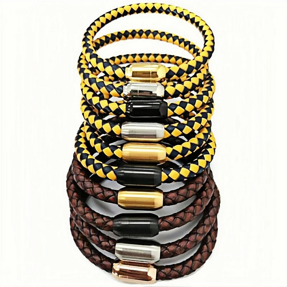 A stack of braided leather bracelets in yellow and black, brown and brown, each with a polished metal cylindrical clasp in gold, silver, and rose gold, set against a plain white background.