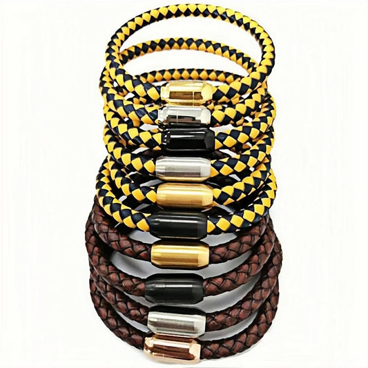 A stack of braided leather bracelets in yellow and black, brown and brown, each with a polished metal cylindrical clasp in gold, silver, and rose gold, set against a plain white background.