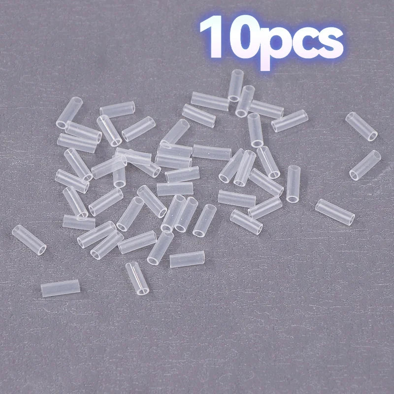Ten small clear cylindrical tube pieces scattered on a gray textured background, with a blue outlined '10pcs' text overlay at the top right.