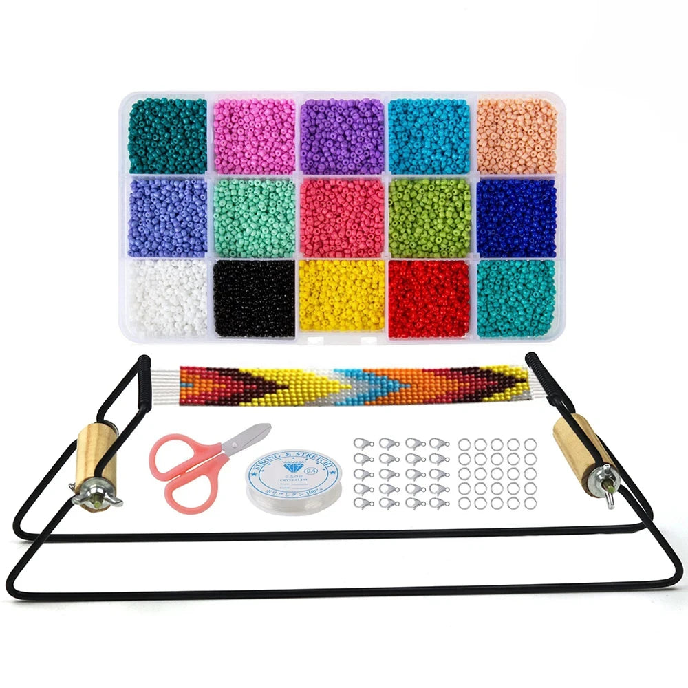 A beaded bracelet kit on a white background, featuring a clear plastic organizer filled with 16 different colors of seed beads, a black elastic bracelet frame with wooden handles, a finished multicolor beaded bracelet, pink-handled scissors, a spool of cord, and silver lobster clasps.