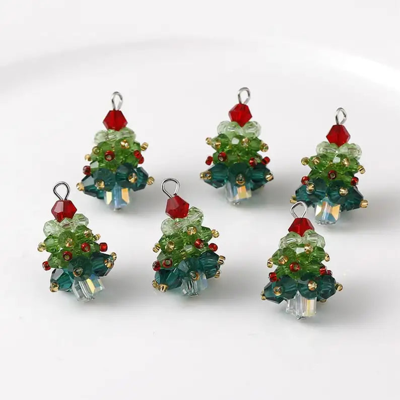 Set of beaded Christmas tree ornaments on a white background