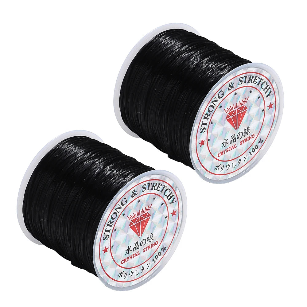 Two spools of black thread with labels on a white background