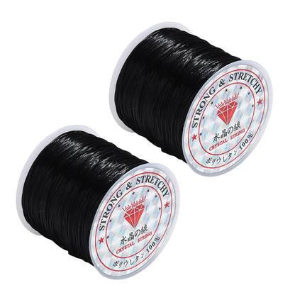 Two spools of black thread with labels on a white background