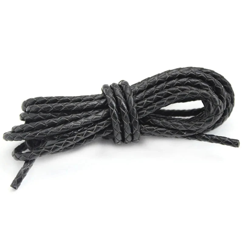 Black leather cord tied into a knot on a white background