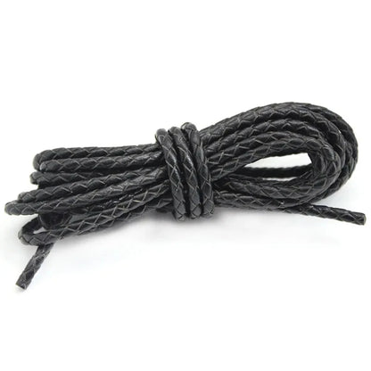 Black leather cord tied into a knot on a white background