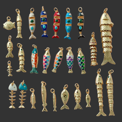 Collection of various fish-shaped pendants on a light pink background