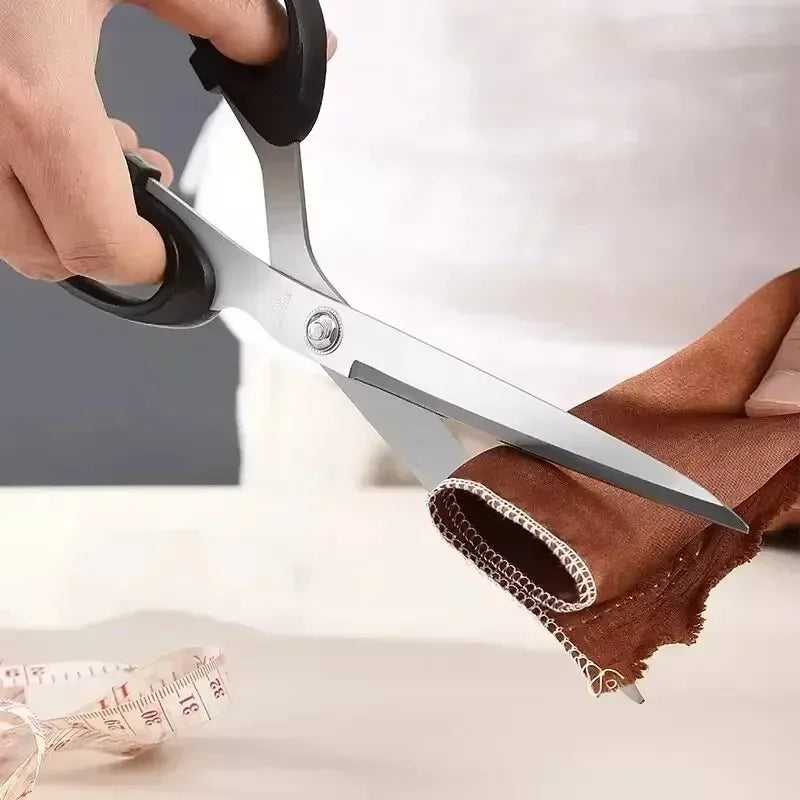 Scissors cutting fabric with a measuring tape in the background