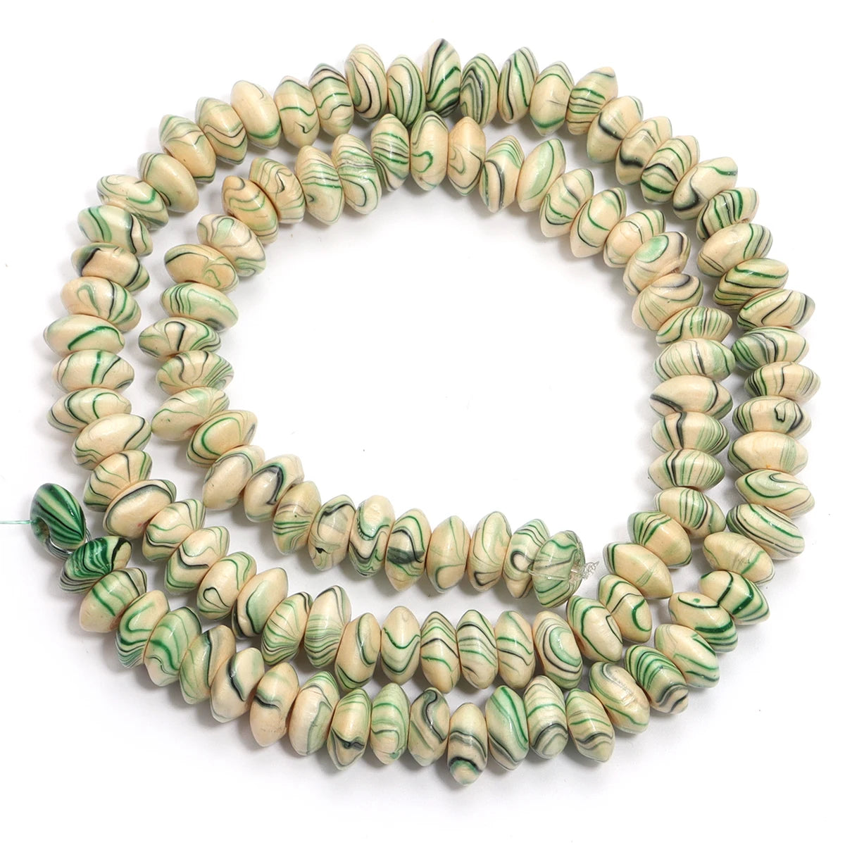 String of green and beige marbled beads on a white background