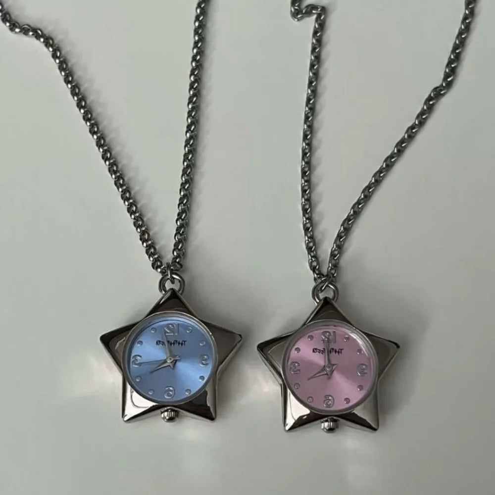 Two star-shaped pendant watches on chains against a light gray background