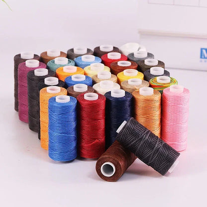 Assorted colorful spools of thread on a white background