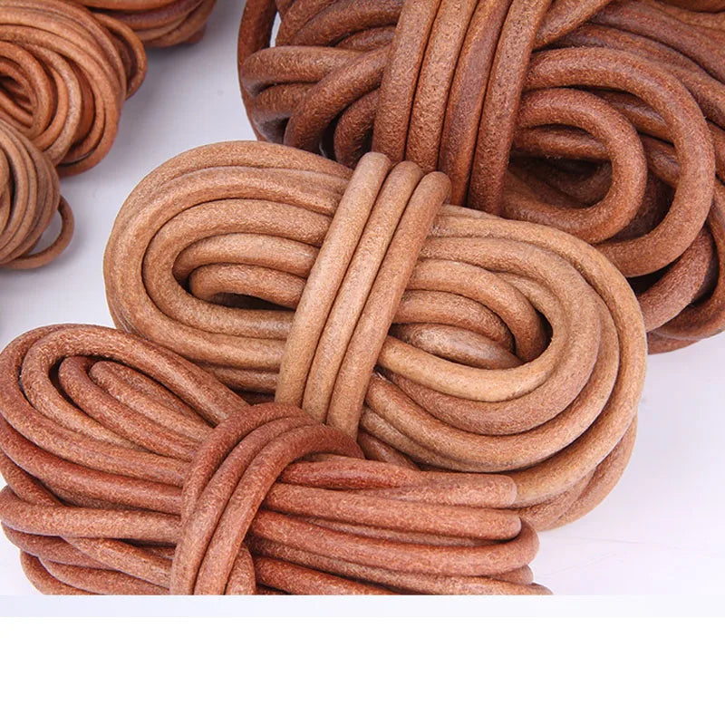 Coiled brown leather cords or straps bundled together on a white background.