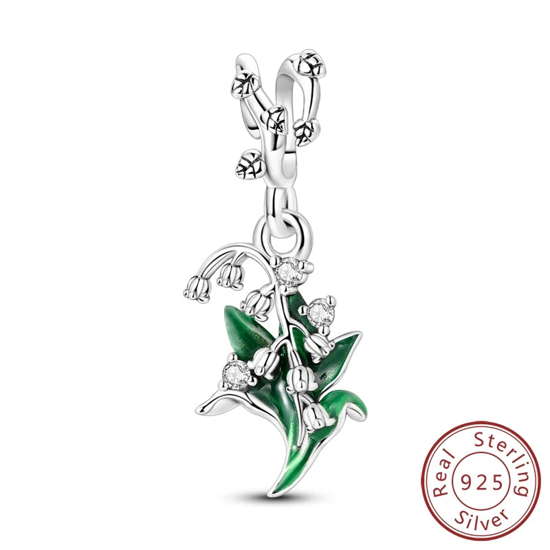 Silver pendant with green leaf design and 'Real Sterling Silver 925' stamp on a white background