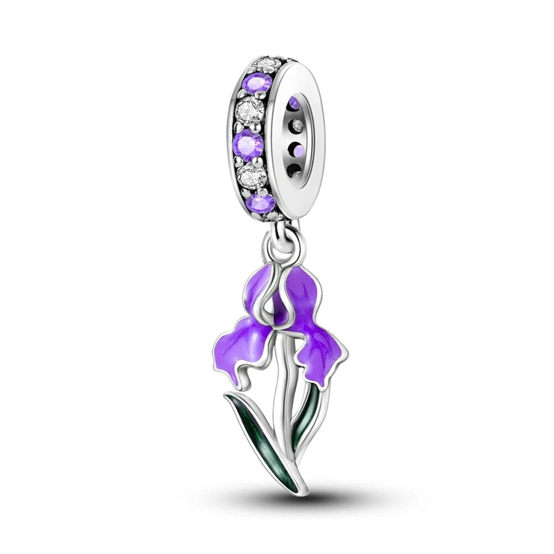 Purple flower charm with embedded stones on a white background