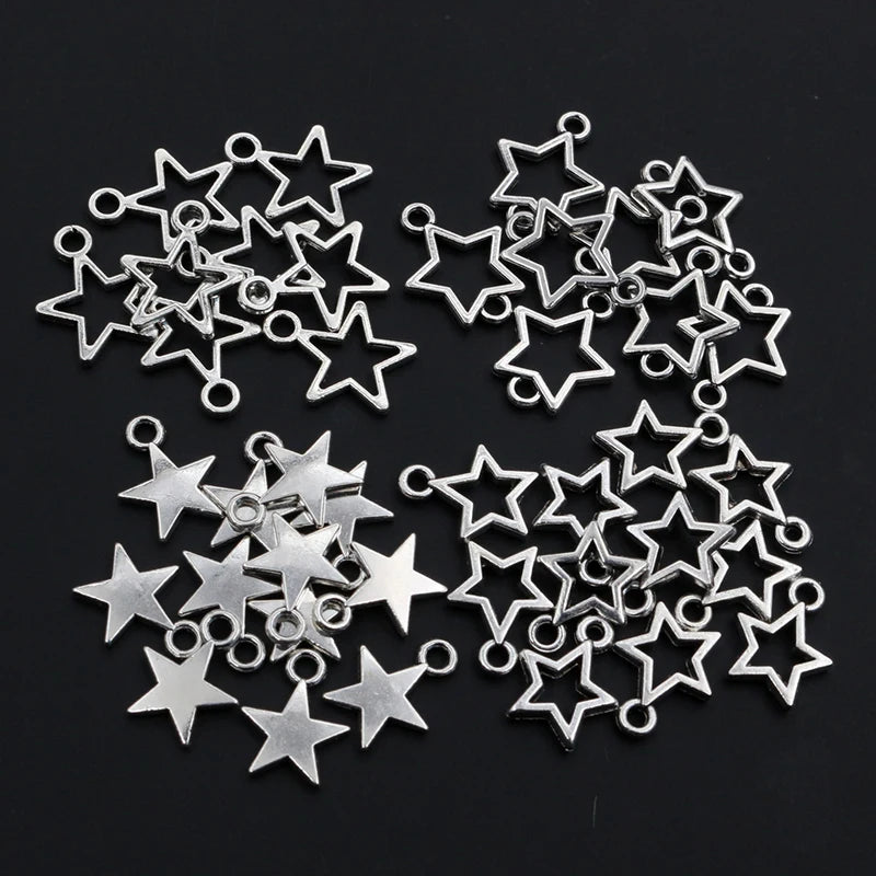 Collection of silver star-shaped jewelry charms on a black background
