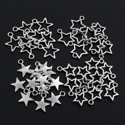 Collection of silver star-shaped jewelry charms on a black background