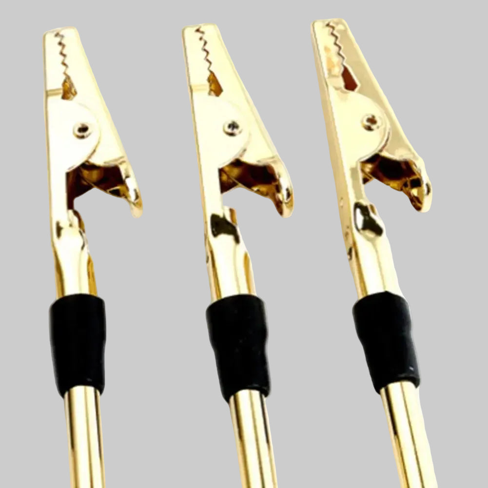 Three gold clamps with black ends on a white background