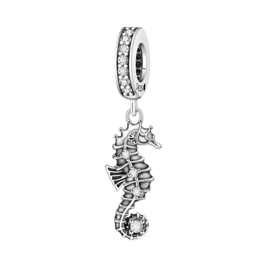 A silver seahorse charm bead featuring a dangling seahorse and seashell design, embellished with clear rhinestones, shown on a plain white background.
