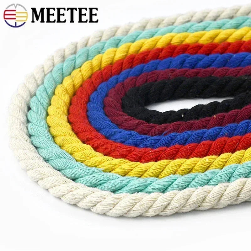 A coiled set of thick braided rope in multiple colors, including cream, light blue, yellow, red, royal blue, and black.