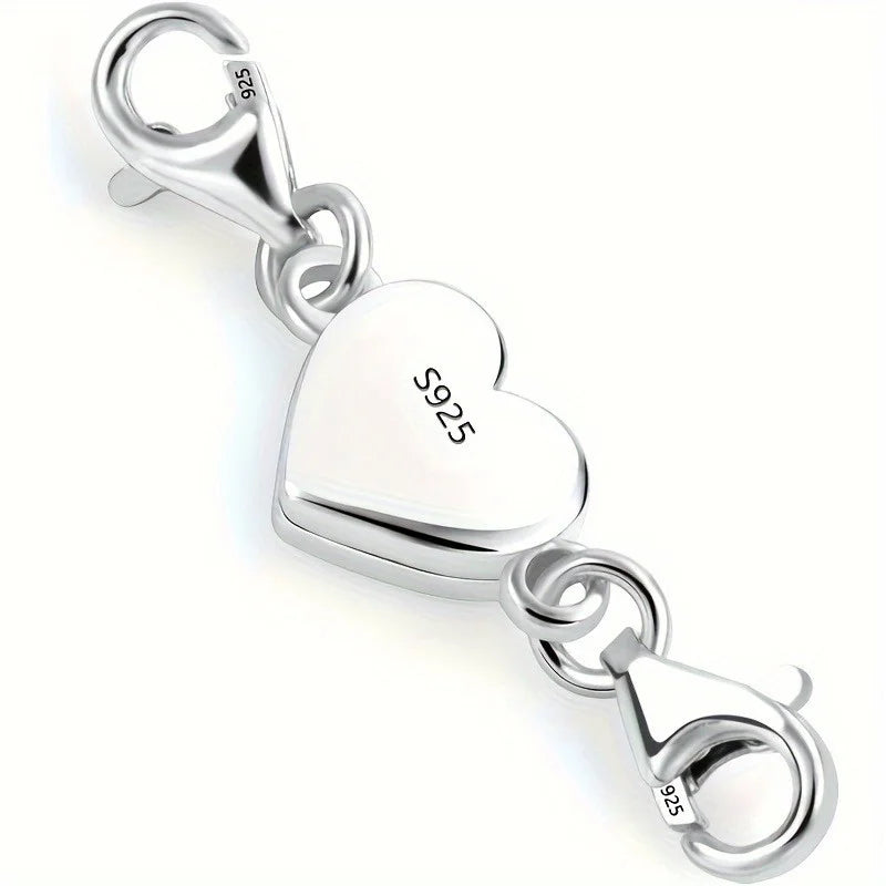 Silver heart-shaped charm with lobster clasp on a white background