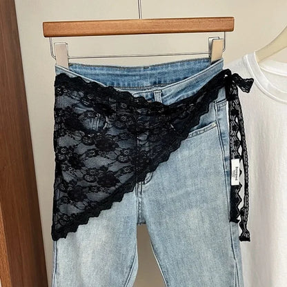 Black lace underwear over blue jeans on a hanger