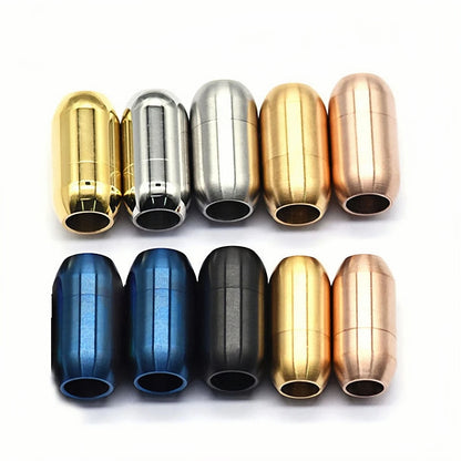 Eight metallic capsule-shaped bracelet clasp pieces arranged in two rows of four on a white background, shown in gold, silver, rose gold, blue, black, and copper finishes.