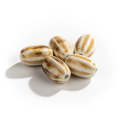 Five striped ceramic beads with brown and cream patterns, arranged on a white background with soft shadows.
