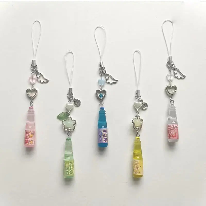 Five colorful phone charm clips on a white background