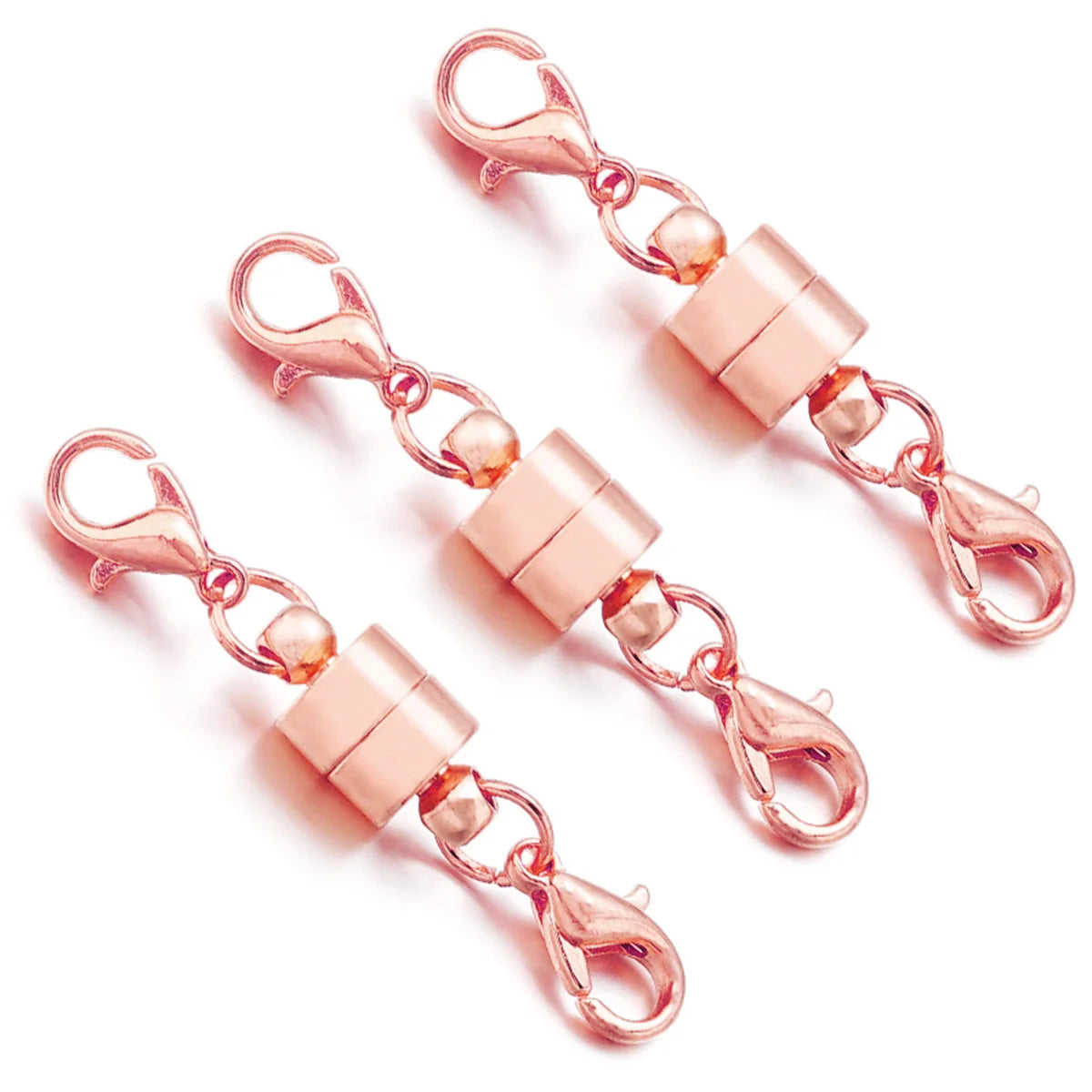 Rose gold keychain clips on a white background