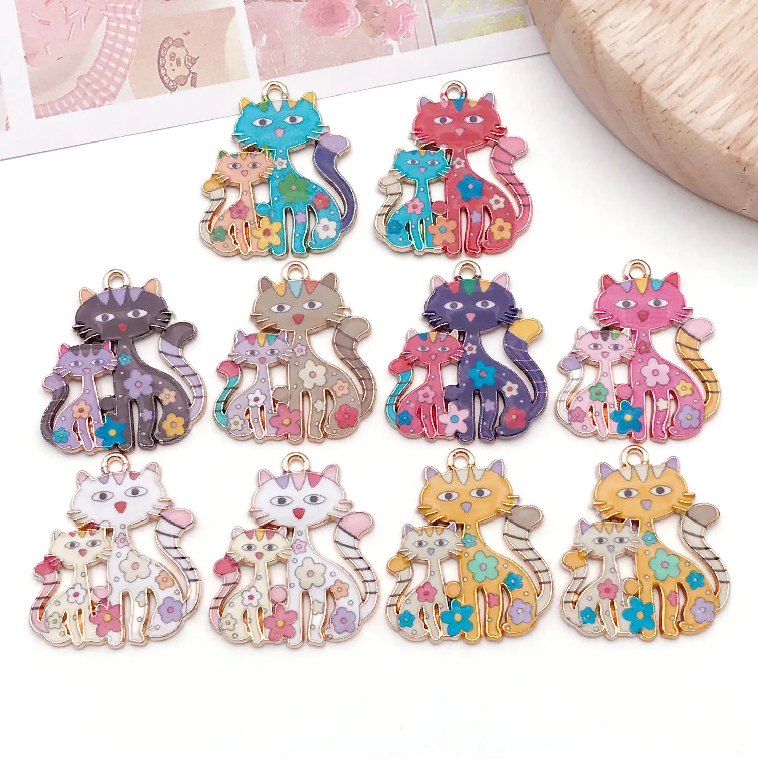 Colorful cat-shaped charms on a white surface