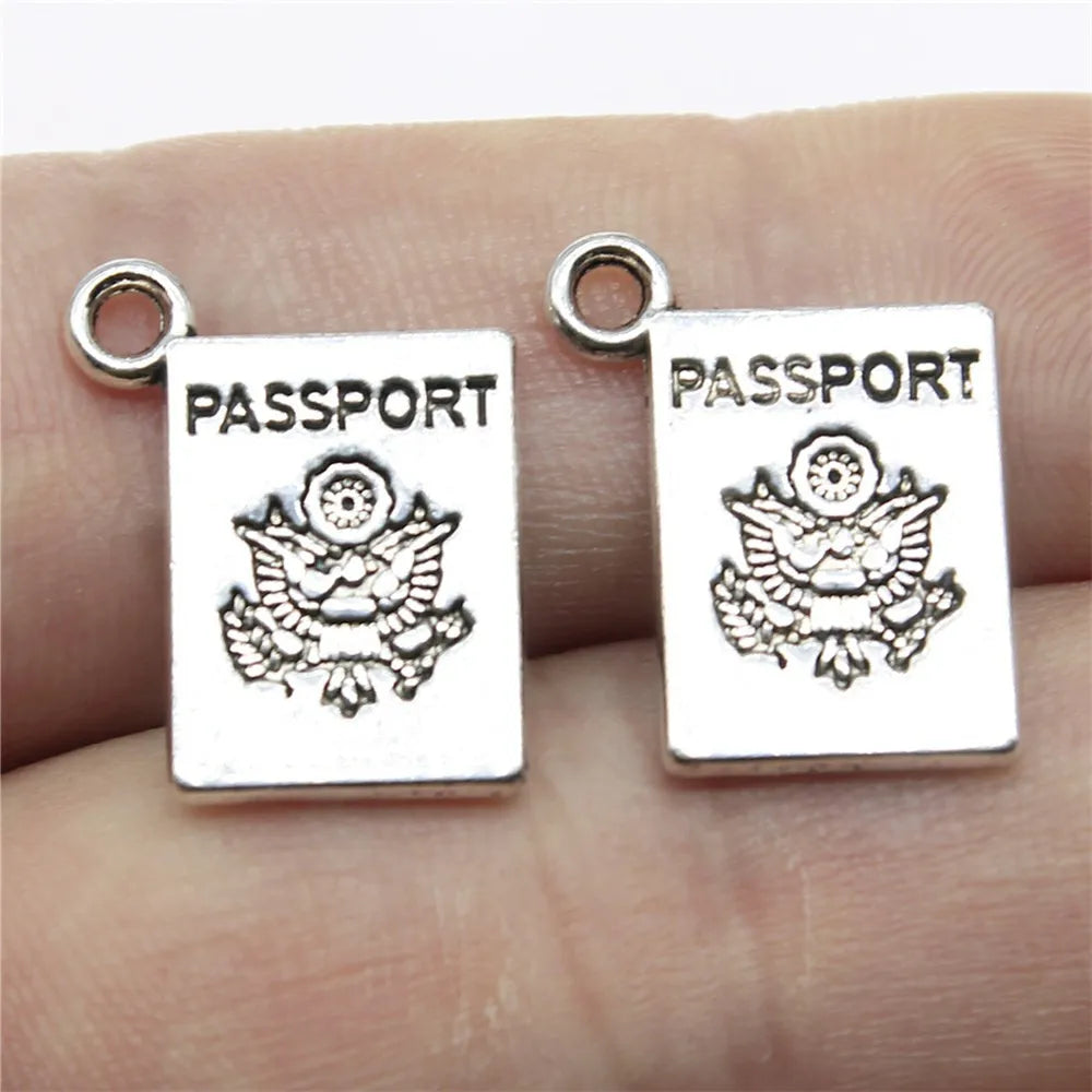 Travel charms for jewelry making featuring airplane, passport, suitcase and camera charms.