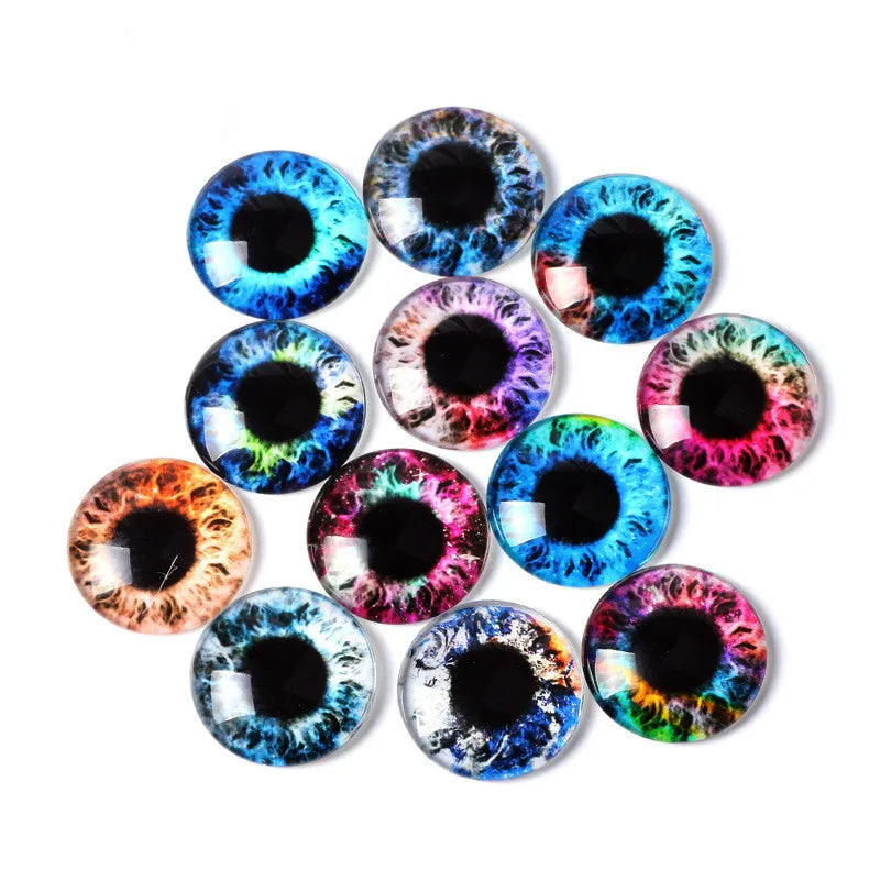 Twelve round faux-eyeball craft beads with colorful iris patterns, arranged in a loose circle on a solid white background.