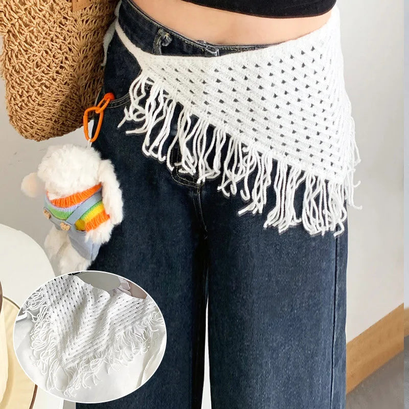 Person wearing a white crochet fringe item over dark jeans with a close-up inset of the fringe.