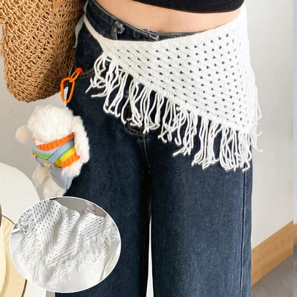 Person wearing a white crochet fringe item over dark jeans with a close-up inset of the fringe.