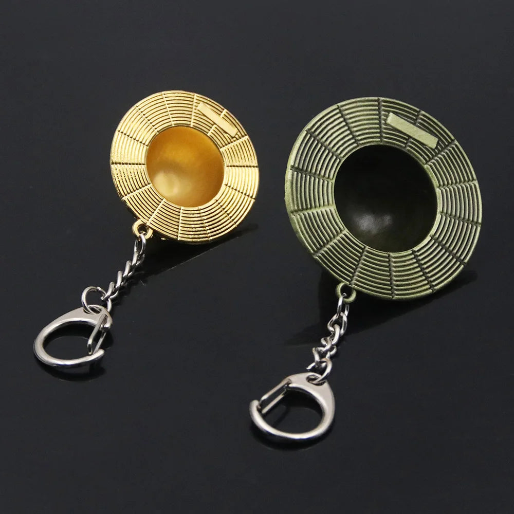 Two decorative keychains with intricate designs on a black background
