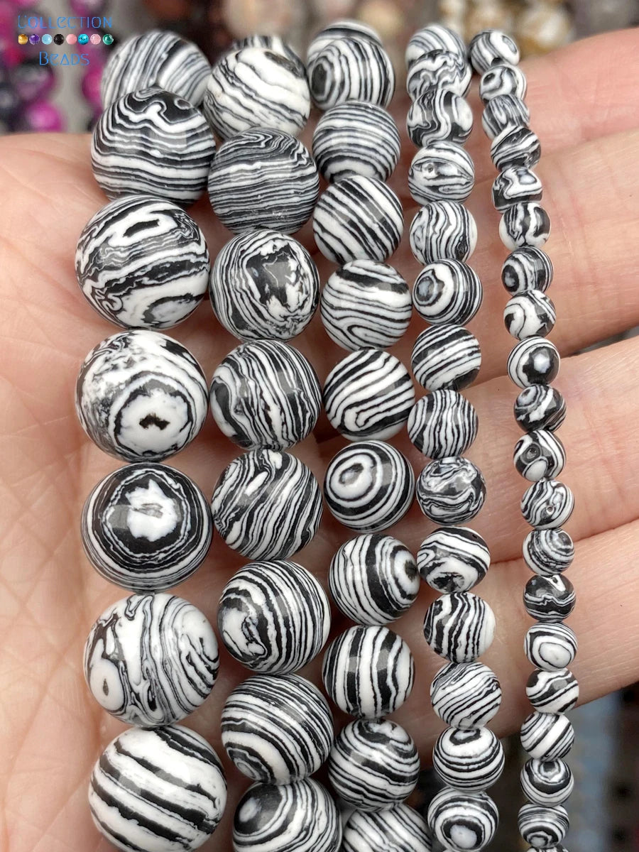 Black and white marbled beads on a hand