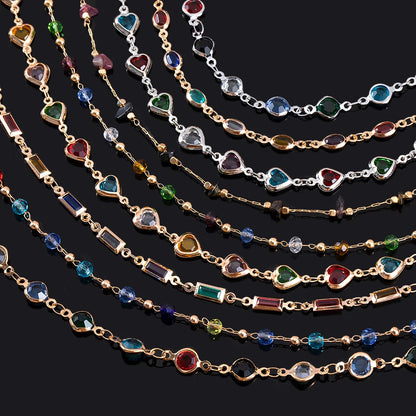 Multiple gold necklaces with colorful gemstones on a black background