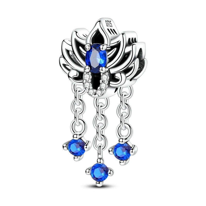 Silver pendant with blue gemstones on a white background