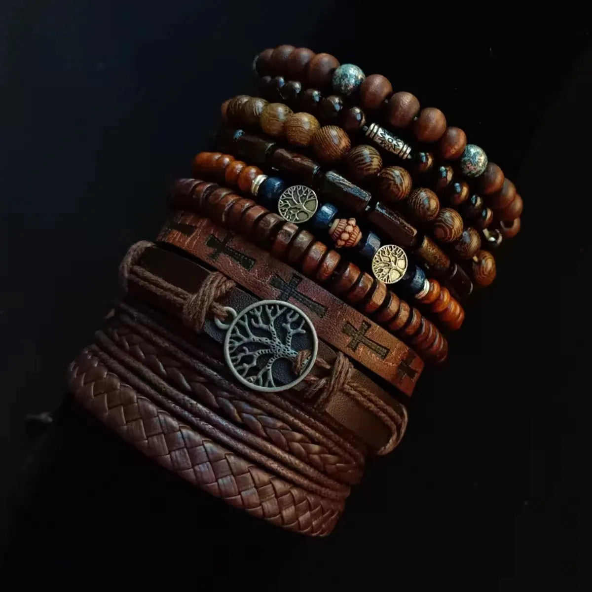 Stack of brown leather and beaded bracelets on a dark background
