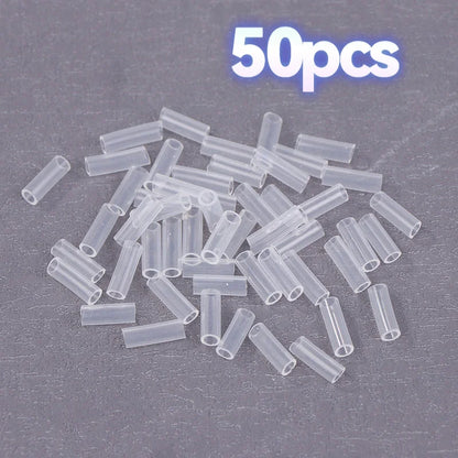 A pile of small clear plastic tube connectors on a dark gray textured background, with a white '50pcs' text overlay at the top.